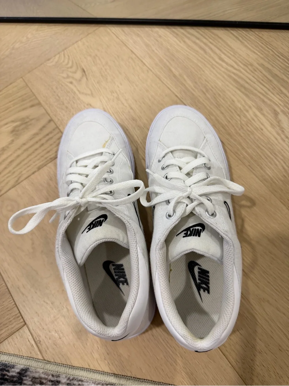 Nike Women’s White Canvas Sneakers with Black Swoosh
